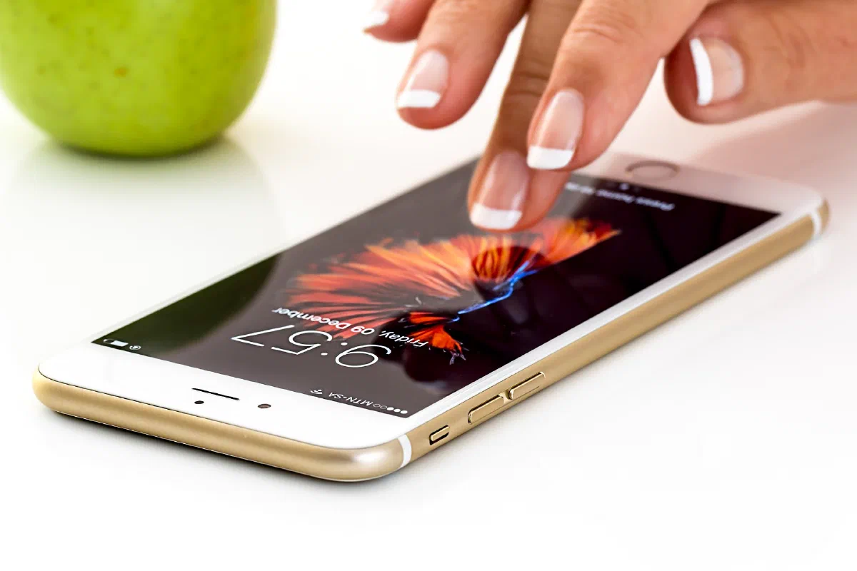 Lady touching iPhone screen